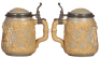 Three Mettlach steins, .5L, 1055 [2271], PUG, pewter lid, mint; .5L, 2182, relief, inlaid lid, mint; .5L, 1370, inliad lid, missing center hinge ring, otherwise mint. - 4