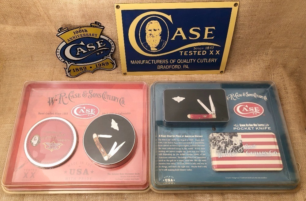 Two Case Signs and Two Commemorative Case Folders in Tins
