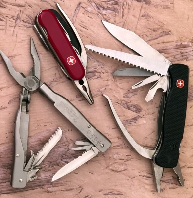 Two Wenger and a Buck Multitools